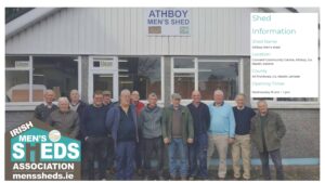 Athboy Men's Shed members posing outside their building.