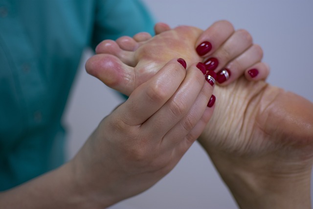 A person receiving a foot massage from another person at Holistic Hands Therapy.