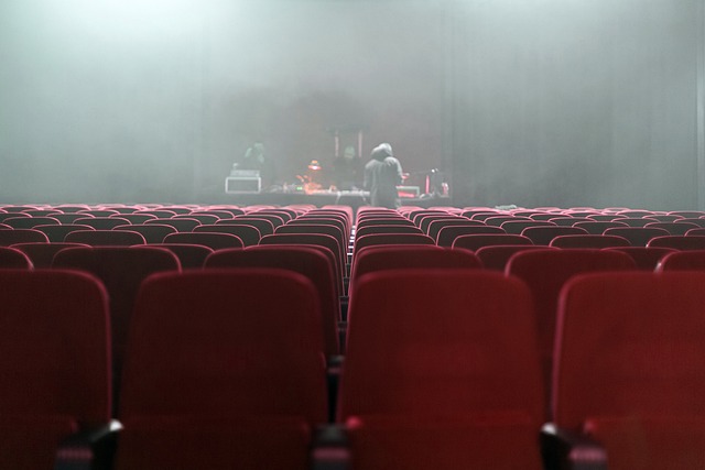 Foggy theater with empty red seats.