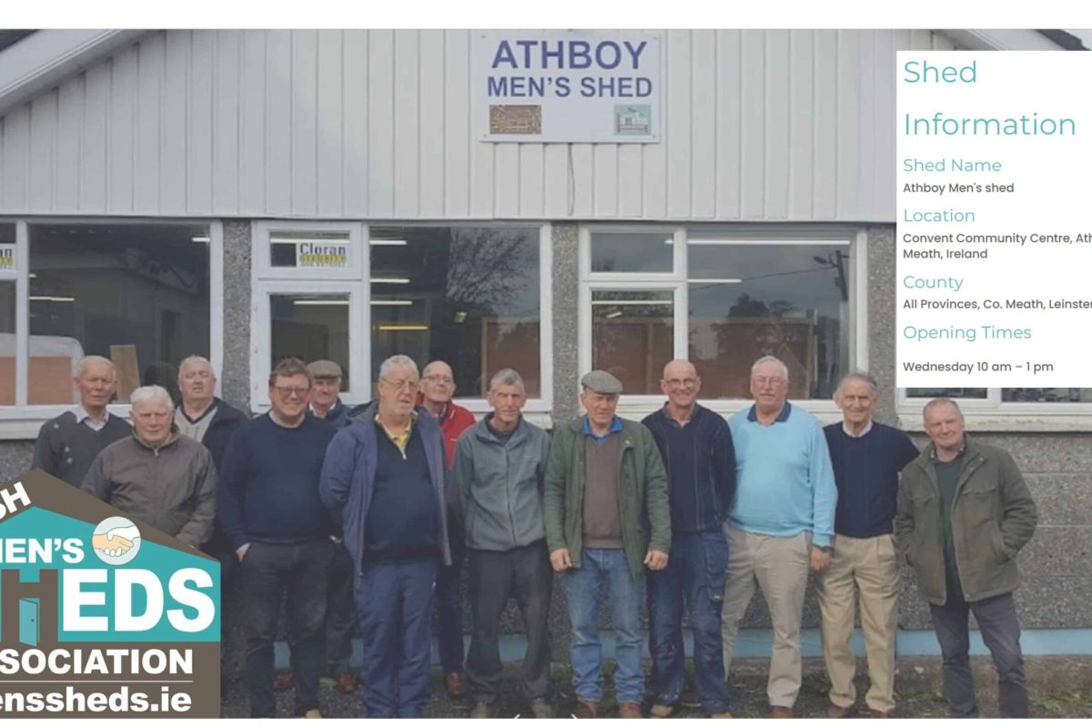 Athboy Men's Shed members posing outside their building.