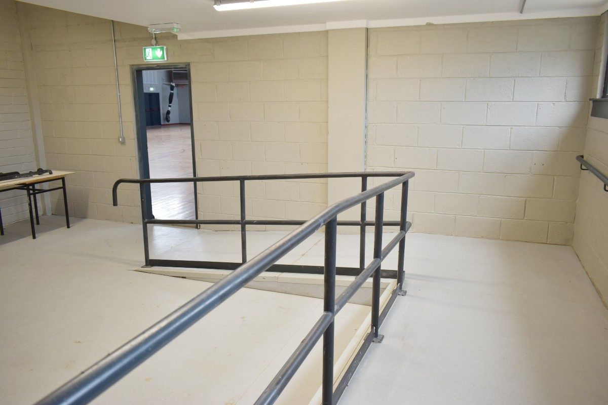 A wheelchair accessible stairway with railing at Athboy CCC Hall.