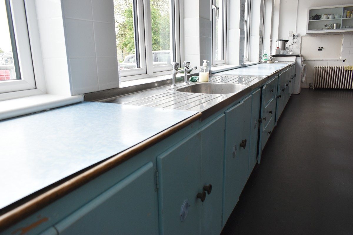 A row of blue cabinets, neatly aligned, stretching out in a long line.