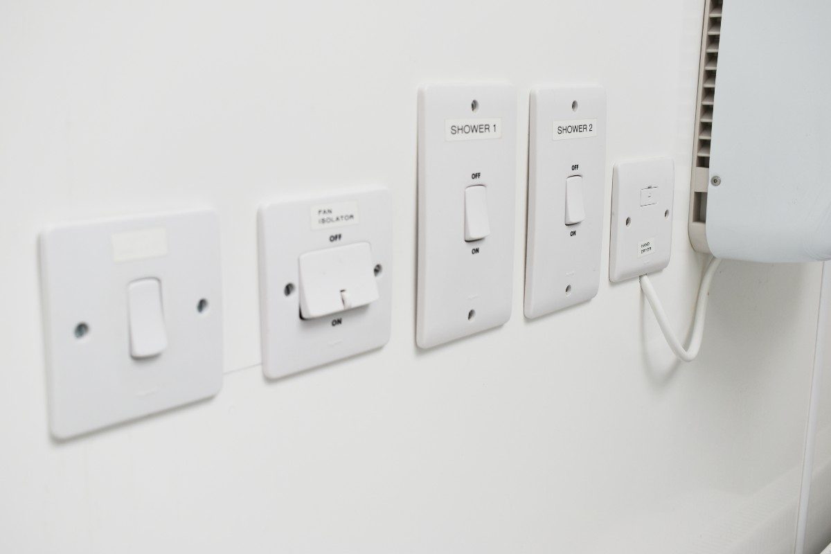 White wall with multiple switches.