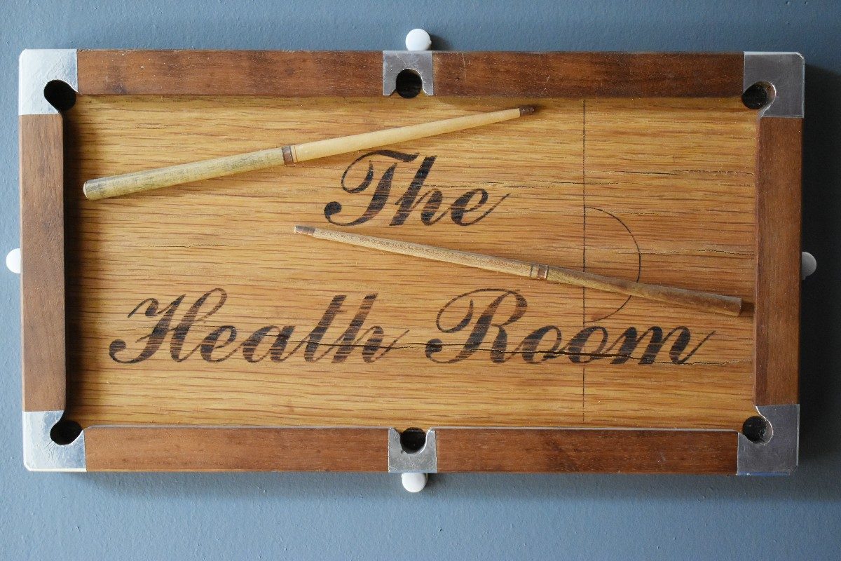 Wooden sign saying 'the health room'.