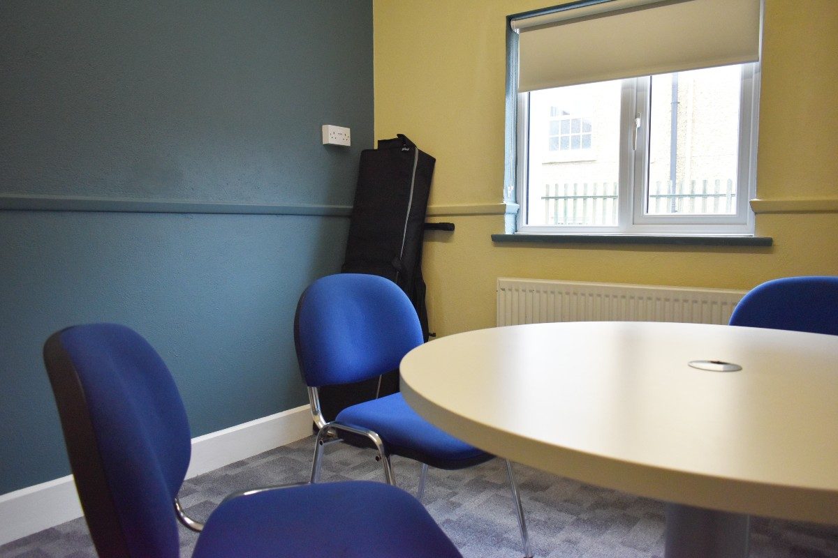 A resource room table with four chairs for collaborative work or meetings.