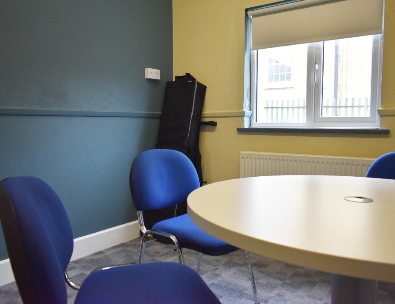 A resource room table with four chairs for collaborative work or meetings.