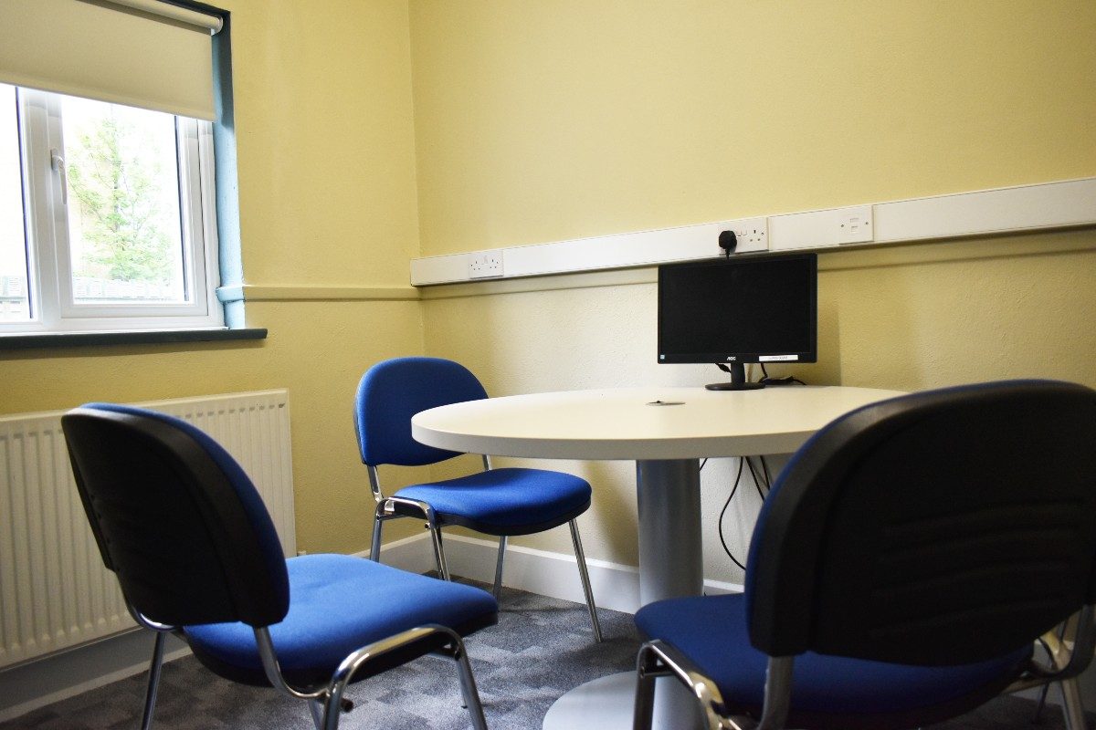 A resource room table with four chairs for collaborative work or meetings.