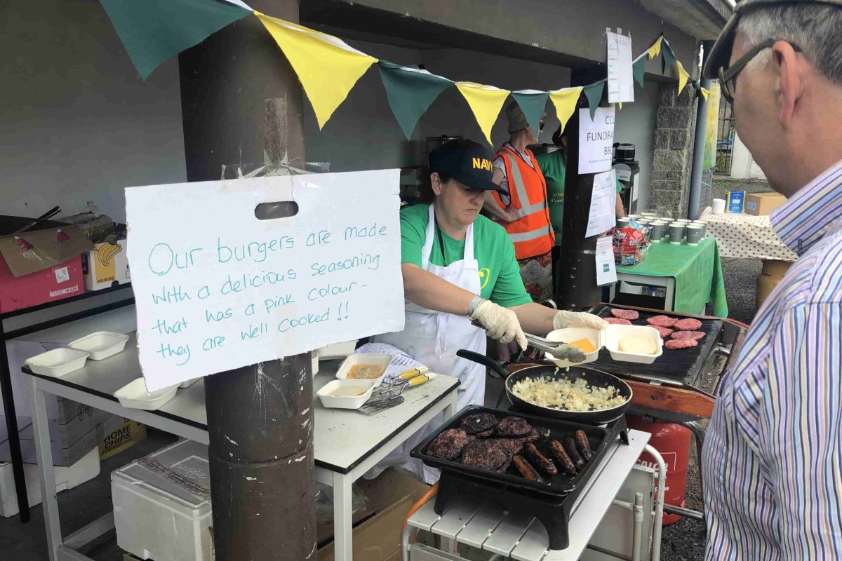 A person grilling food on a barbecue, creating a delicious outdoor feast.